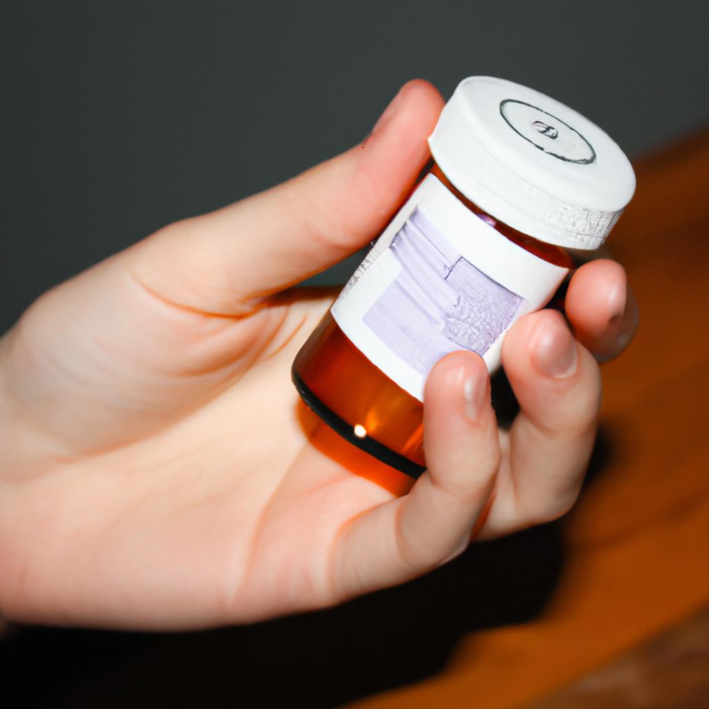 Person holding prescription medication bottle